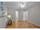 Neutral bedroom featuring hardwood floors, a ceiling fan, and multiple doorways to other rooms at 205 Town Creek Dr, Cary, NC 27519