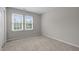 Carpeted bedroom with neutral paint, base molding and natural light from two windows at 205 Town Creek Dr, Cary, NC 27519