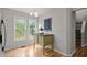 Breakfast nook with hardwood floors, windows, and a modern cabinet with a black countertop at 205 Town Creek Dr, Cary, NC 27519
