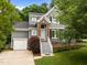 Charming two-story home featuring a brick entrance, landscaped yard, and a convenient one-car garage at 205 Town Creek Dr, Cary, NC 27519