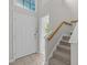 Inviting foyer featuring tiled floors, stairs, and decorative window above the front door at 205 Town Creek Dr, Cary, NC 27519