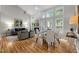 Open-concept living and dining area with hardwood floors, fireplace, and abundant natural light at 205 Town Creek Dr, Cary, NC 27519