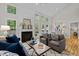 Bright living room with fireplace, vaulted ceilings, multiple windows, and hardwood floors at 205 Town Creek Dr, Cary, NC 27519