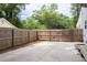 Fenced backyard with a concrete patio and access to wood deck, offering ample privacy at 212 E Rockway St, Durham, NC 27704