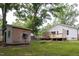 Charming backyard featuring a wooden shed, spacious deck, and lush green lawn at 212 E Rockway St, Durham, NC 27704