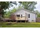 White home's backyard featuring a multi-level wooden deck, and a well maintained lawn at 212 E Rockway St, Durham, NC 27704