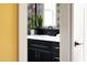 Modern bathroom featuring black cabinets, white countertop, and stylish decor at 212 E Rockway St, Durham, NC 27704
