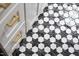 Close up of the black and white patterned tile flooring in the bathroom at 212 E Rockway St, Durham, NC 27704
