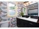 Stylish bathroom features a modern vanity with unique bird-themed wallpaper and lots of natural light at 212 E Rockway St, Durham, NC 27704