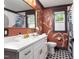Stylish bathroom with modern fixtures, bold wallpaper and a black and white tiled floor at 212 E Rockway St, Durham, NC 27704