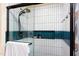 Modern bathroom showcases a glass door shower with white subway tile and unique blue accent tiles at 212 E Rockway St, Durham, NC 27704