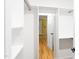 Walk-in closet with ample shelving and rod space, leading to a bedroom with yellow walls at 212 E Rockway St, Durham, NC 27704