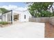 Spacious driveway leading to a charming white home with a welcoming front porch and wood accents at 212 E Rockway St, Durham, NC 27704
