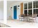Charming front porch with bright blue door, black sconces, shutters, and stone base at 212 E Rockway St, Durham, NC 27704