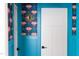 Hallway boasts bold teal accents, white doors, and vibrant floral-themed wallpaper to add a touch of fun at 212 E Rockway St, Durham, NC 27704