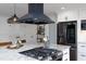 Well-appointed kitchen with white cabinets, granite countertops, and stainless steel appliances offers style and function at 212 E Rockway St, Durham, NC 27704