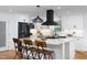 Modern kitchen with white cabinets, black appliances, and granite countertops offering a sleek and functional space at 212 E Rockway St, Durham, NC 27704