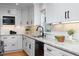 Elegant kitchen featuring white cabinets, granite countertops, and modern fixtures providing a clean, functional space at 212 E Rockway St, Durham, NC 27704