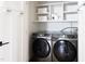 Convenient laundry room with new front load washer and dryer and storage shelving at 212 E Rockway St, Durham, NC 27704