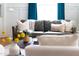 Comfortable living room showcasing a green leather sofa with decorative pillows and a bright window view at 212 E Rockway St, Durham, NC 27704