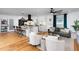 Open-concept living room featuring hardwood floors, kitchen island, white cabinets and modern decor at 212 E Rockway St, Durham, NC 27704