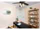 A cozy office space with hardwood floors, stylish shelves, and lots of natural light from the large window at 212 E Rockway St, Durham, NC 27704