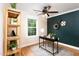 This office boasts dark green accent wall, stylish decor, and lots of natural light from the large window at 212 E Rockway St, Durham, NC 27704