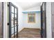 Bright shed interior featuring wood floors, window, and a fresh coat of paint at 212 E Rockway St, Durham, NC 27704