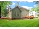 Expansive backyard featuring a large, well-maintained lawn and mature trees surrounding the property at 216 Lewey Brook Dr, Cary, NC 27519