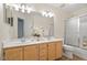 Bathroom featuring a double sink vanity with recessed lighting, ample mirror space, and a shower at 216 Lewey Brook Dr, Cary, NC 27519