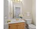 Powder room featuring a modern toilet and vanity with traditional finishes and gold hardware at 216 Lewey Brook Dr, Cary, NC 27519