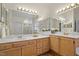 Bright bathroom featuring a double sink vanity, white countertops, and ample mirror space at 216 Lewey Brook Dr, Cary, NC 27519