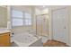 Bathroom with a soaking tub and a glass door shower with tile flooring at 216 Lewey Brook Dr, Cary, NC 27519