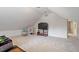Expansive bonus room with a large flat screen television for entertainment at 216 Lewey Brook Dr, Cary, NC 27519