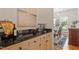 Convenient butler's pantry with wood cabinetry, granite countertop, and views to dining room at 216 Lewey Brook Dr, Cary, NC 27519