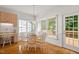 Inviting dining area with natural light, with desk and door to deck at 216 Lewey Brook Dr, Cary, NC 27519
