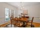 Elegant dining room featuring hardwood floors, a chandelier, and a large window at 216 Lewey Brook Dr, Cary, NC 27519