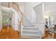 Bright and airy entryway featuring hardwood floors, a staircase, and a view of the living spaces at 216 Lewey Brook Dr, Cary, NC 27519