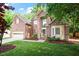 Charming two-story brick home featuring a well-manicured lawn and an attached two car garage at 216 Lewey Brook Dr, Cary, NC 27519