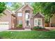 Charming two-story brick home featuring a well-manicured lawn and an inviting entryway at 216 Lewey Brook Dr, Cary, NC 27519