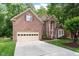 Beautiful two-story brick home featuring an attached two car garage and a spacious driveway at 216 Lewey Brook Dr, Cary, NC 27519