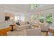 Bright living room with hardwood floors and large windows showcasing natural light at 216 Lewey Brook Dr, Cary, NC 27519
