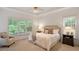 Serene main bedroom suite featuring a seating area and tray ceiling at 216 Lewey Brook Dr, Cary, NC 27519