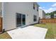 A fenced backyard featuring a concrete patio, lawn, and sliding glass doors leading into the home at 2208 Seneca Dr, Raleigh, NC 27604