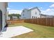 A spacious backyard with a concrete patio, a wood fence, and freshly cut grass at 2208 Seneca Dr, Raleigh, NC 27604