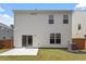 Backyard view featuring a concrete patio, privacy fence, and well-maintained lawn at 2208 Seneca Dr, Raleigh, NC 27604