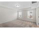 Well-lit bedroom featuring two windows, neutral carpet, and tray ceilings at 2208 Seneca Dr, Raleigh, NC 27604