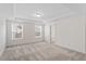 Spacious bedroom with neutral carpet, tray ceiling, and natural light from the large windows at 2208 Seneca Dr, Raleigh, NC 27604