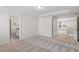 Bright, carpeted bedroom with en suite bathroom, tray ceilings, and ample natural light at 2208 Seneca Dr, Raleigh, NC 27604