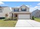 Charming two-story home featuring a two-car garage, well-manicured lawn, and beautiful brick and siding exterior at 2208 Seneca Dr, Raleigh, NC 27604